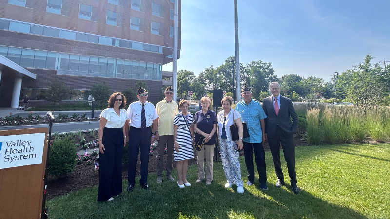 men and women posing for photo at flag day ceremony