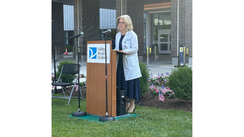 employee speaking into microphone at podium