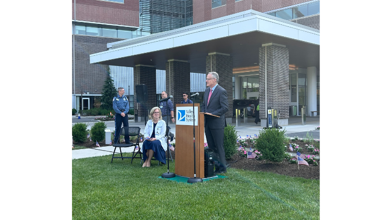 employee speaking into microphone at podium
