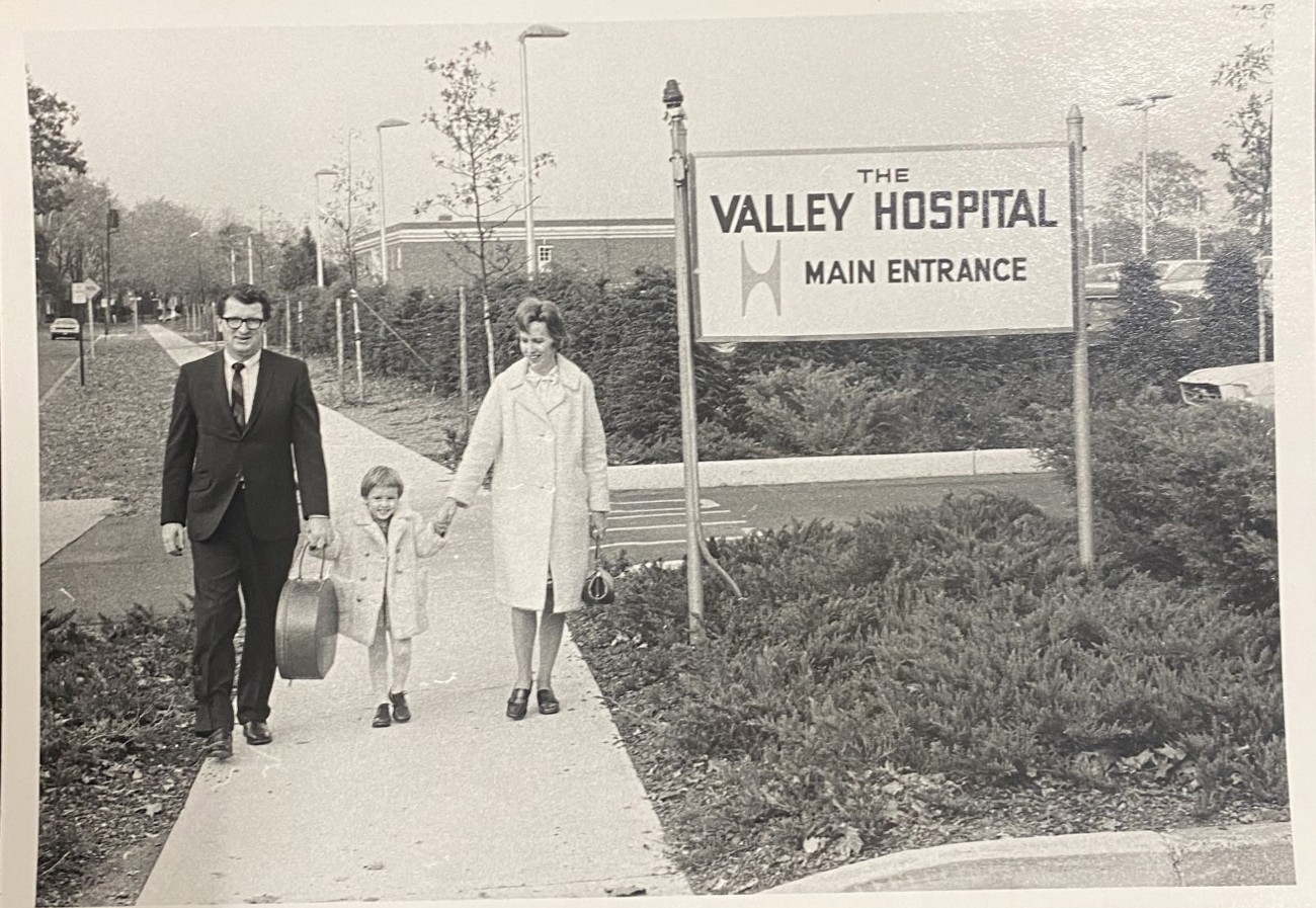 child with his parents walking into The valley hospital on opening day