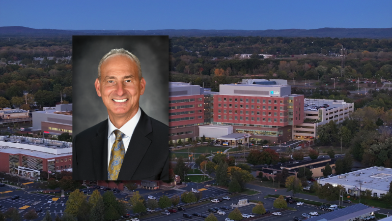 Headshot of Rob Brenner, MD, against the backdrop of The Valley Hospital